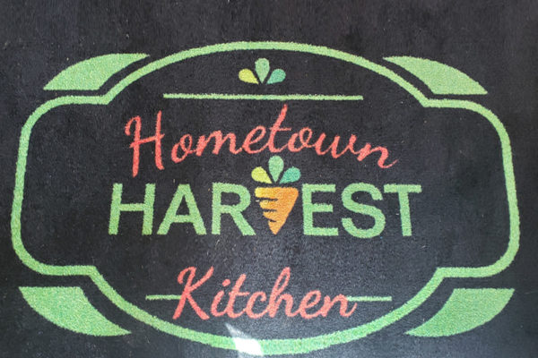 Graphic Design Project: Hometown Harvest Kitchen logo, on a carpet